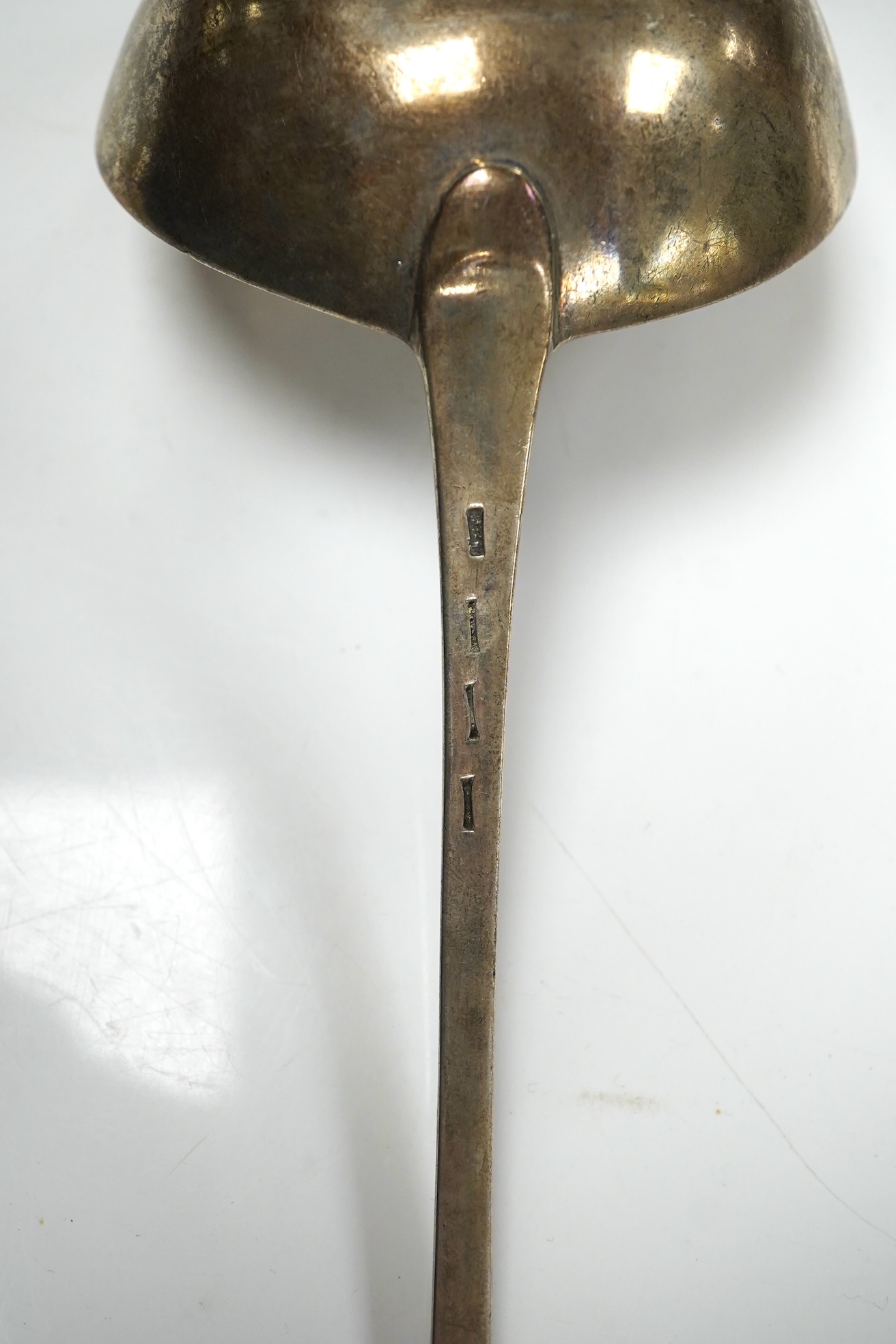 An 18ct century silver Old English pattern soup ladle, pinched marks, 32.8cm, 4.5oz. Condition - poor to fair